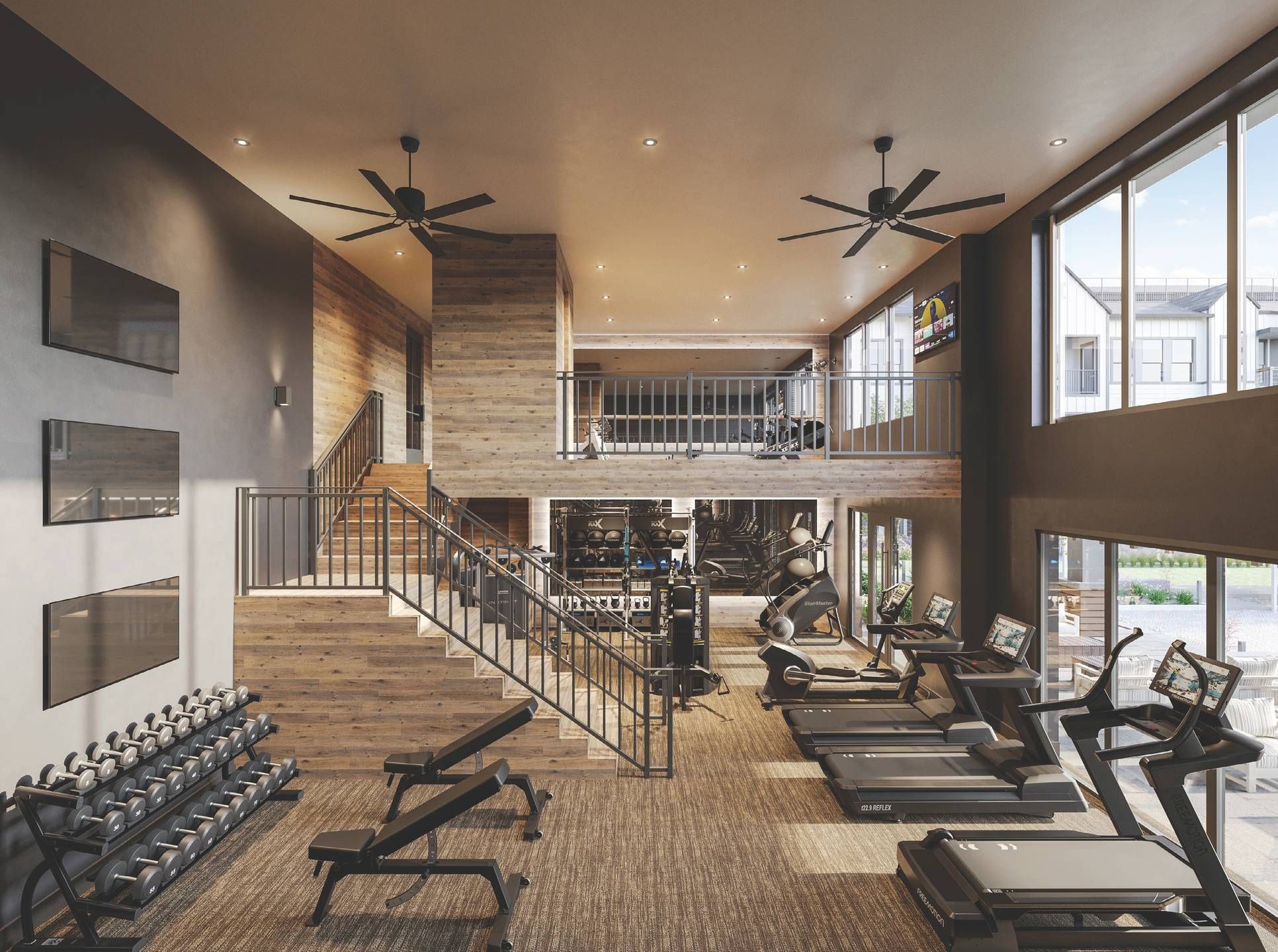 Landhaus at Gruen Modern gym with treadmills, free weights, and exercise machines, featuring large windows and a loft area.